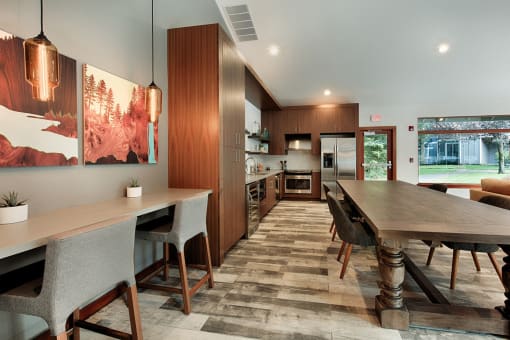 Communal dining space with wood cabinetry and pendant lights at Canyon Creek Apartments, Oregon, 97070