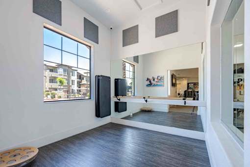 A room with a large window and a view of the city.