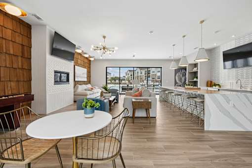 A modern kitchen and dining area with a white table and chairs.