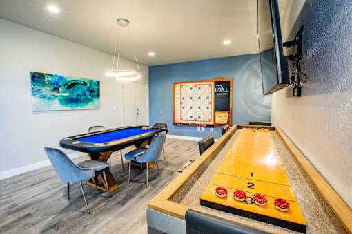 A pool table with a blue cloth and a cue ball in the middle of the table.