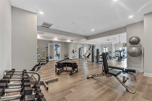 A spacious gym with a variety of equipment including treadmills, weights, and exercise machines.