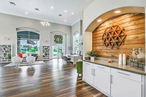 A modern kitchen with white cabinets and a wooden backsplash.
