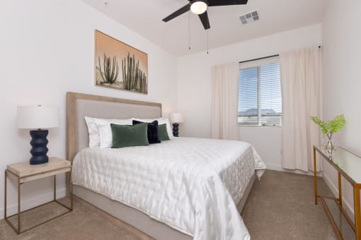 a bedroom with a large white bed and a ceiling fan at Element 12 Apartments, Henderson NV