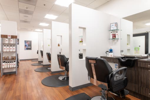 a salon with white walls and wood flooring