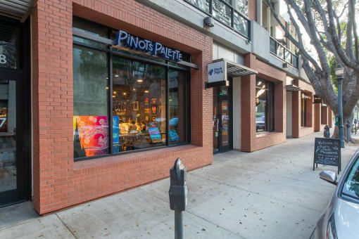 a brick building with a window and a parking meter