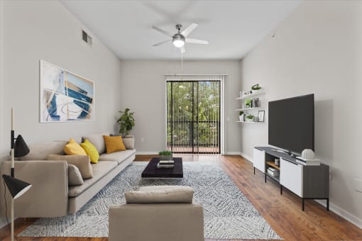 a living room with white walls and a sliding glass door