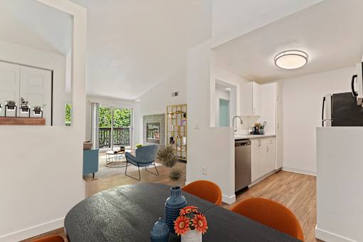 A modern kitchen with a dining table and chairs.