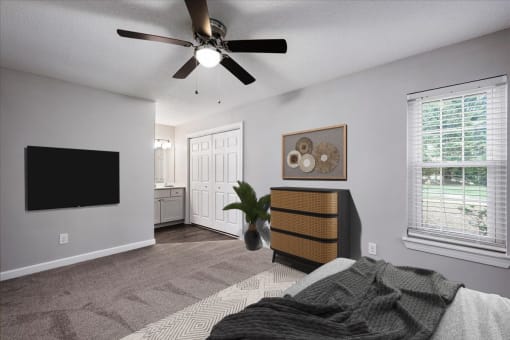 a bedroom with a bed and a ceiling fan