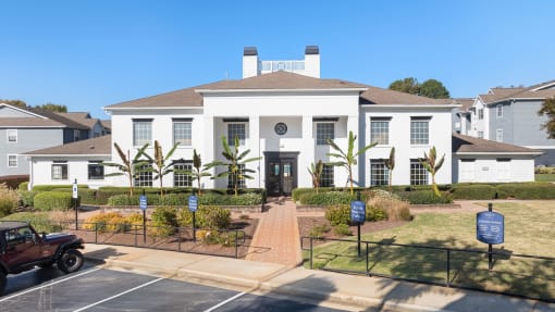 leasing office with palm tress in front of it