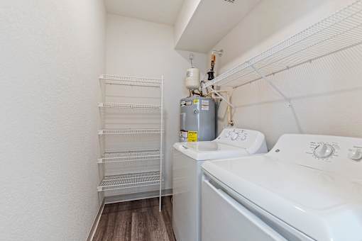 A small laundry room with a washer and dryer.
