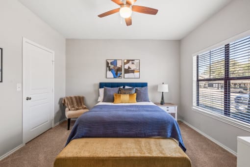 a bedroom with a bed and a ceiling fan