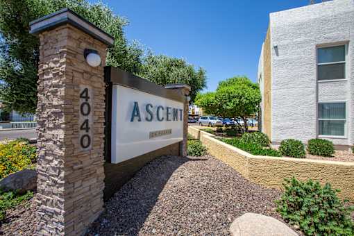 A stone pillar with the number 404 on it stands in front of a sign that says "Ascent".