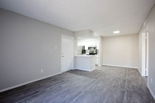 A room with a grey floor and a white wall.