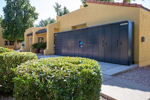 A yellow house with a black garage door.