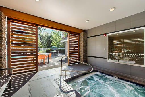 Indoor hot tub with patio access and privacy screens at Canyon Creek Apartments, Oregon, 97070