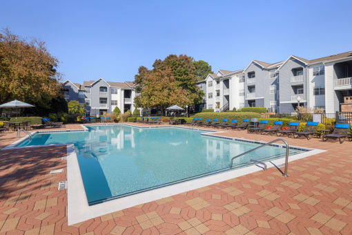 a swimming pool with apartments in the background
