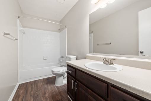 Brown Cabinets White counter tops in bathroom