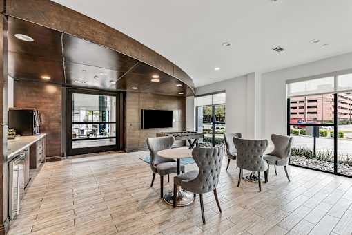 A modern kitchen with a dining table and chairs.
