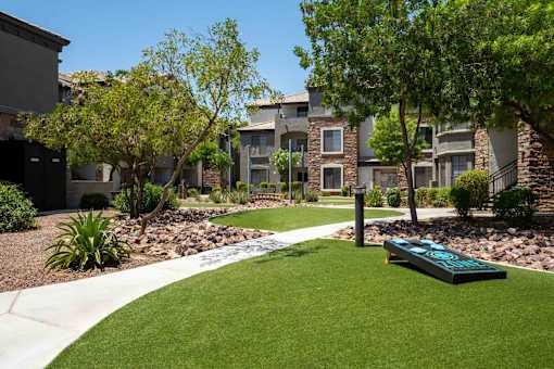 A grassy area in front of apartment buildings.