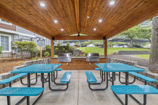 Covered bbq area with picnic tables and grills at Canyon Creek Apartments, Wilsonville, 97070