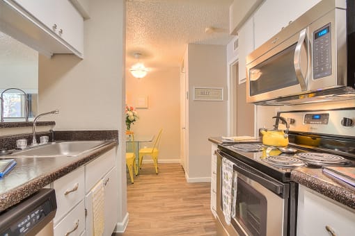 Gourmet Kitchen with Breakfast Bar and Pantry at Eagle Point Apartments, New Mexico, 87111