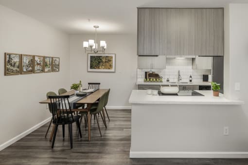 Open kitchen with white subway tile and dining area at Canyon Creek Apartments, Wilsonville, Oregon
