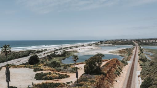 a view of the beach and the freeway next to the ocean