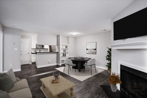 a living room with a table and chairs and a fireplace