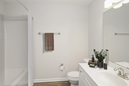 a bathroom with white walls and a white toilet next to a white sink
