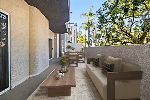 Patio with a couch, chairs, and a coffee table at Cahuenga Heights, Los Angeles, California