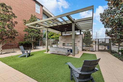 A patio with a table and chairs under a roof.