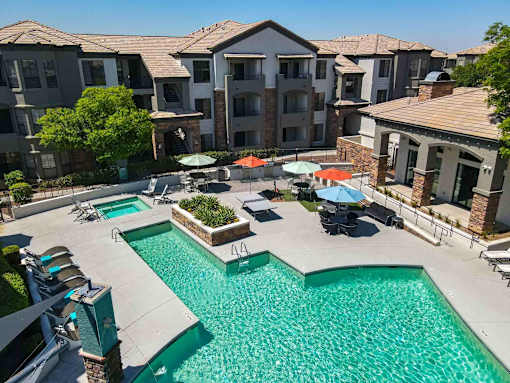 A swimming pool surrounded by apartment buildings.