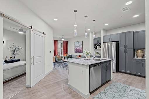 A modern kitchen with a large island and a dining area.