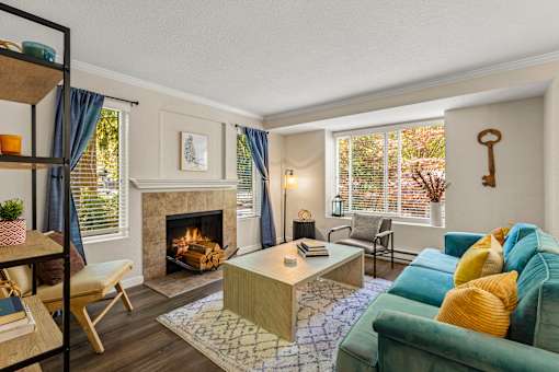 Living room with fireplace and modern furnishings at Hubbard's Crossing Apartments, Kirkland, 98034