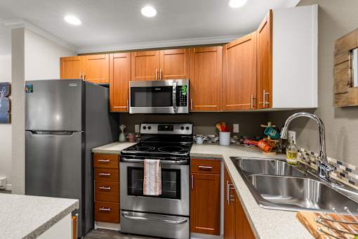 Modern kitchen with stainless steel appliances at Hubbard's Crossing Apartments, Washington