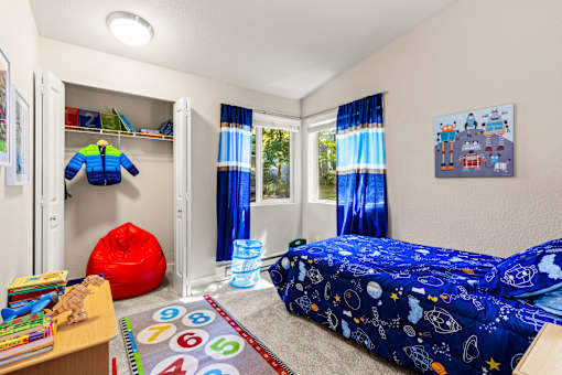 Kids bedroom with space themed bedding and toys at Hubbard's Crossing Apartments, Washington
