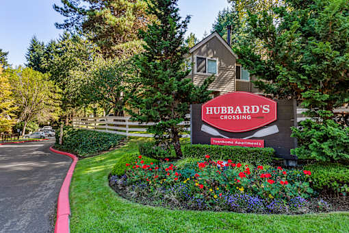 Monument sign with colorful landscaped flower beds at Hubbard's Crossing Apartments, Kirkland, WA 98034