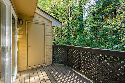 Private balcony with lattice railing and storage at Hubbard's Crossing Apartments, Kirkland, Washington