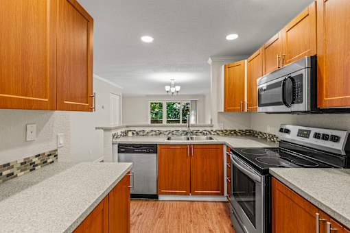 Kitchen with tile backsplash and quartz countertops at Hubbard's Crossing Apartments, Washington, 98034