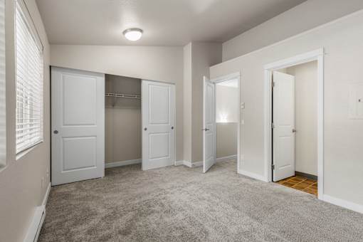 Spacious bedroom with walk-in closet and carpet at Hubbard's Crossing Apartments, Kirkland