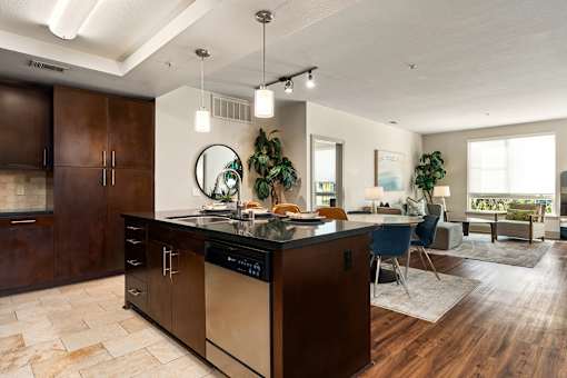 A modern kitchen with dark wood cabinets and a large island.