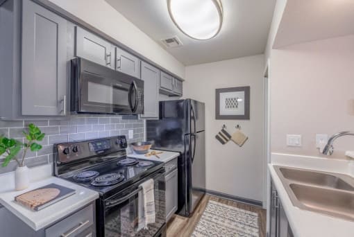 Kitchen with black refrigerator at apartments in Las Vegas, NV.