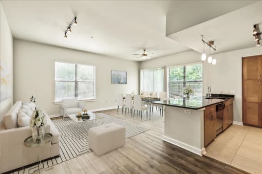 a living and dining room area with white walls and hardwood flooring
