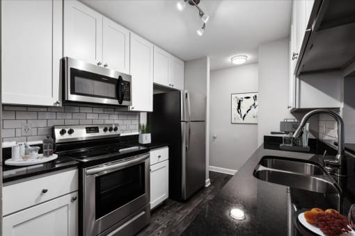 a kitchen with a stove top oven next to a sink
