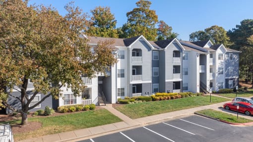 parking lot with apartment building in background