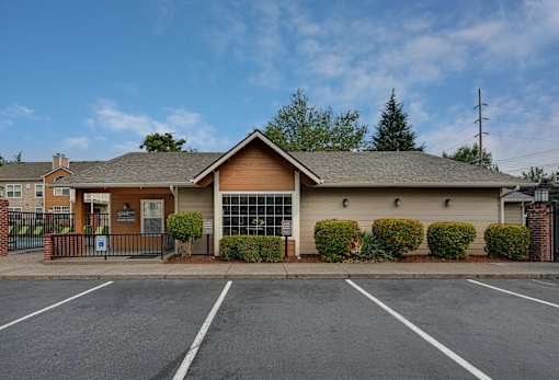 A building with a parking lot in front of it.