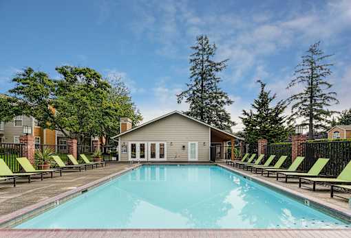 A swimming pool with lounge chairs
