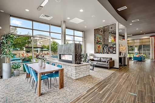 A modern living room with a fireplace and a dining table.