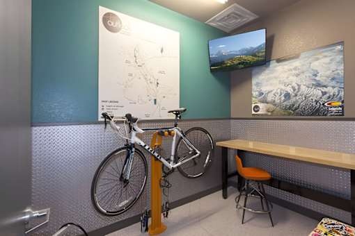 A bike is chained to a stand in a room.