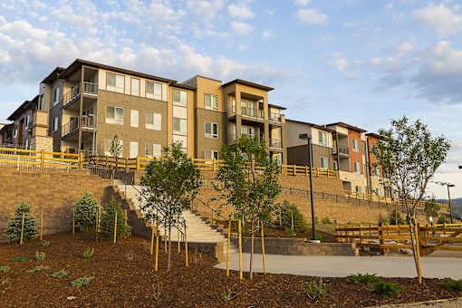 A large apartment complex with a staircase leading to the entrance.